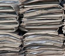 A stack of newspapers is shown stacked on top of each other.