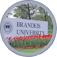 A sign for brandeis university with flowers in the background.