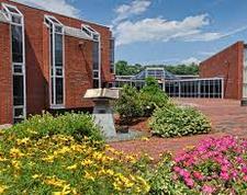 A building with flowers in the front yard.