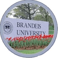 A sign for brandeis university with flowers in the background.