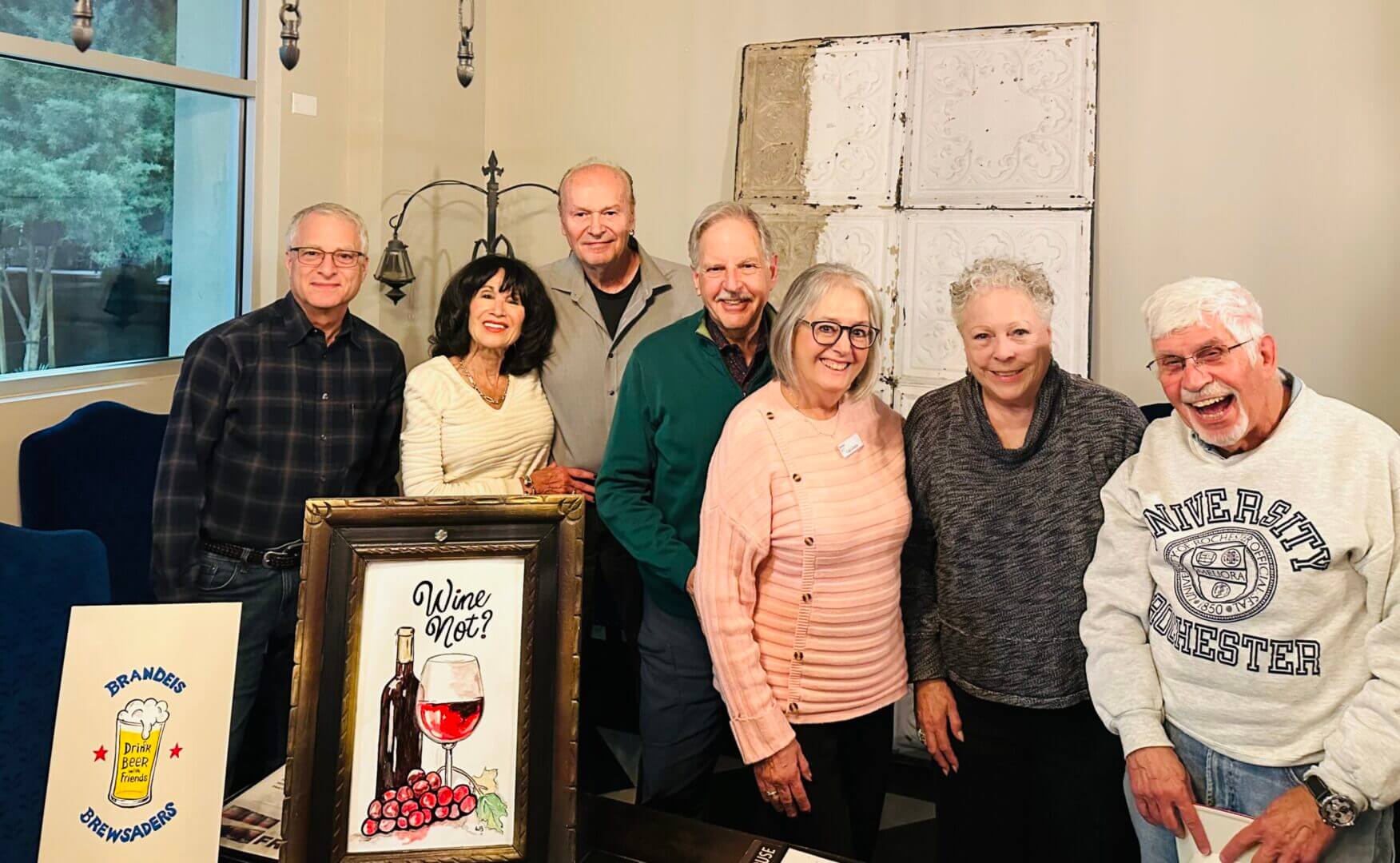 Group of smiling people indoors together.