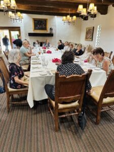 People dining at a large rectangular table.